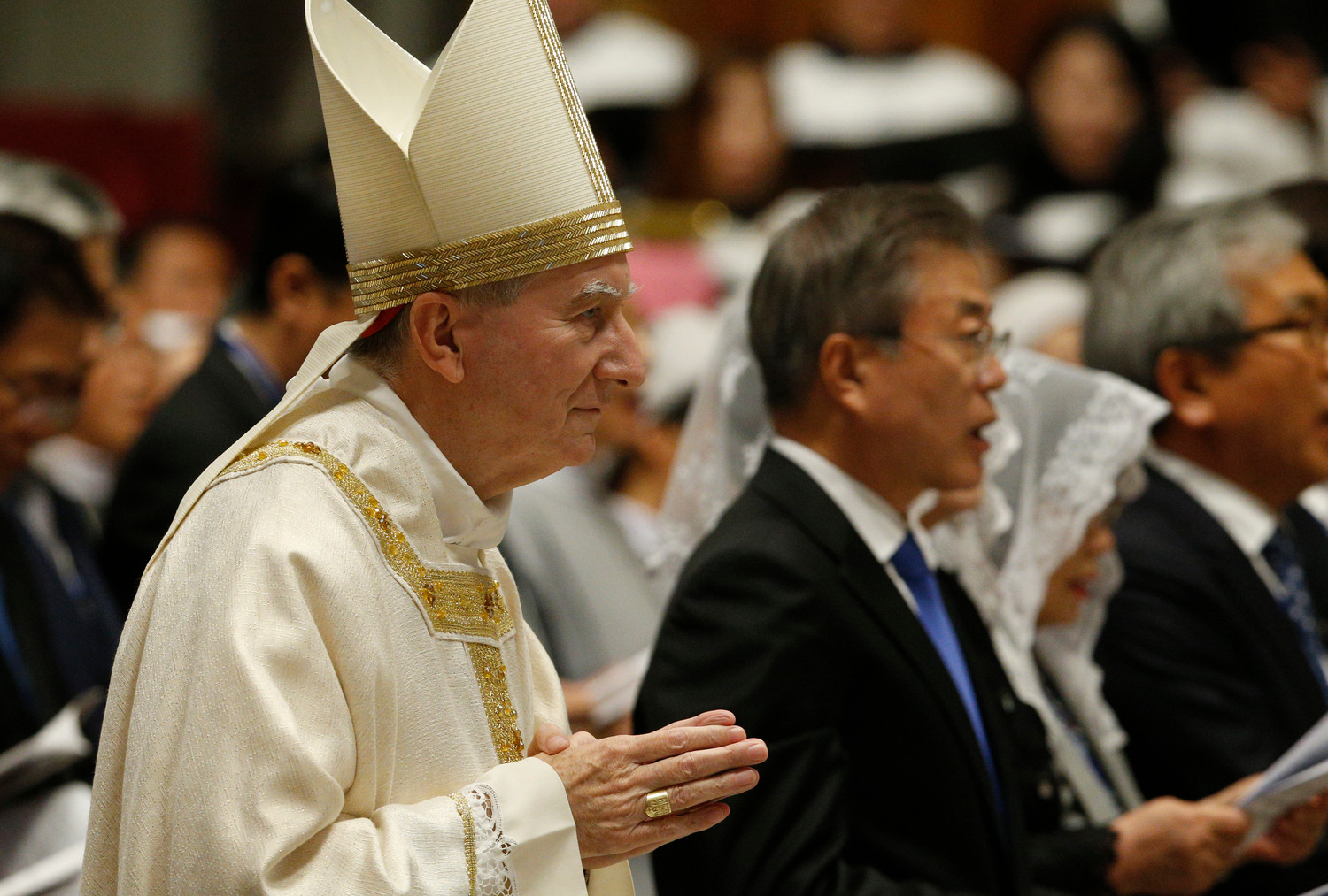 Cardinal Pietro Parolin, Vatican secretary of state, walks past South Korean President Moon Jae-in as he arrives to celebrate a Mass for peace for the Korean peninsula in St. Peter’s Basilica at the Vatican Oct. 17.